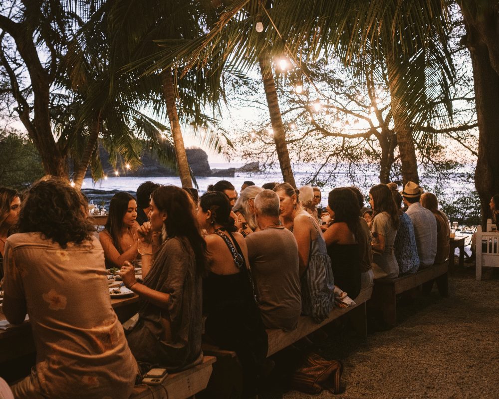 Long communal dinner table at sunset in Nosara