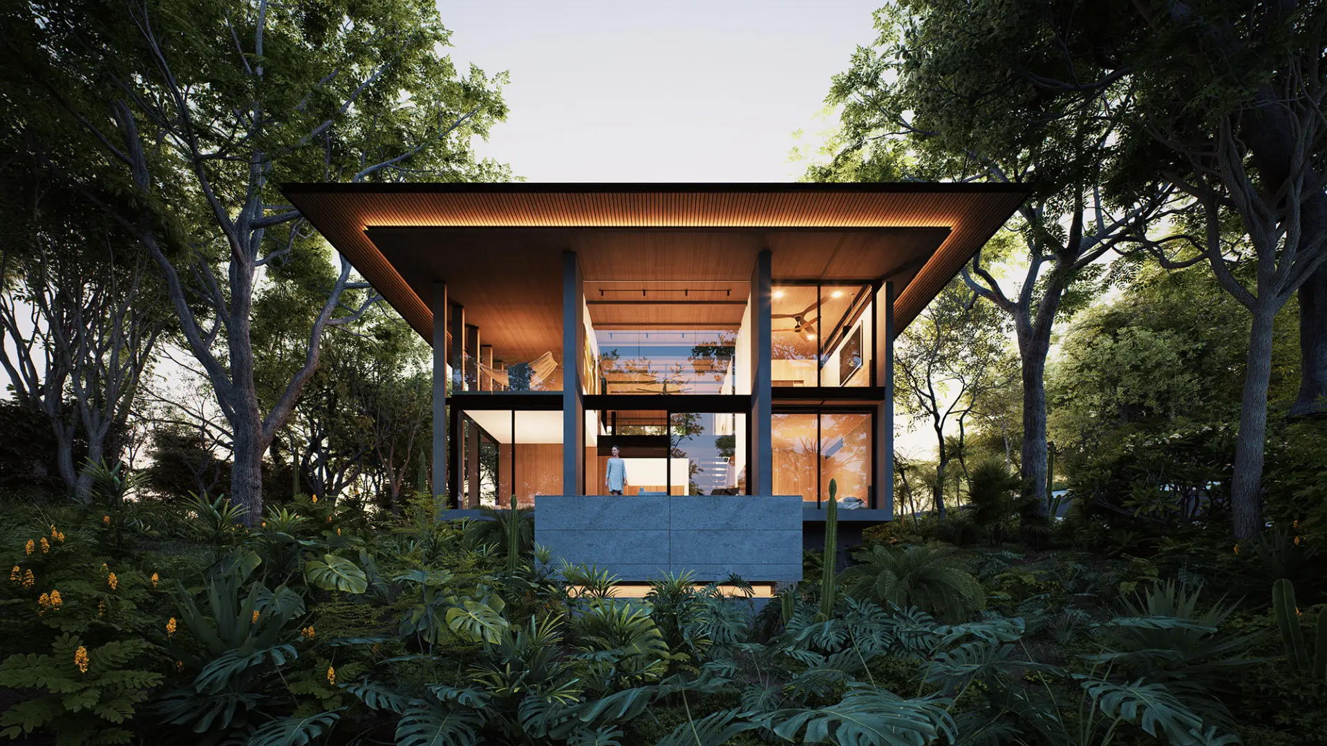 Casa Iki twilight facade rising above the jungle canopy